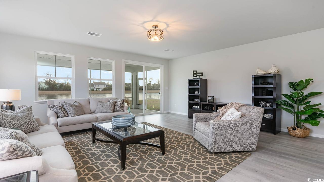 117 Keithland Drive Conway, SC 29527 - Photo 8 of 32 Living area with plenty of natural light, wood finished floors, and a water view