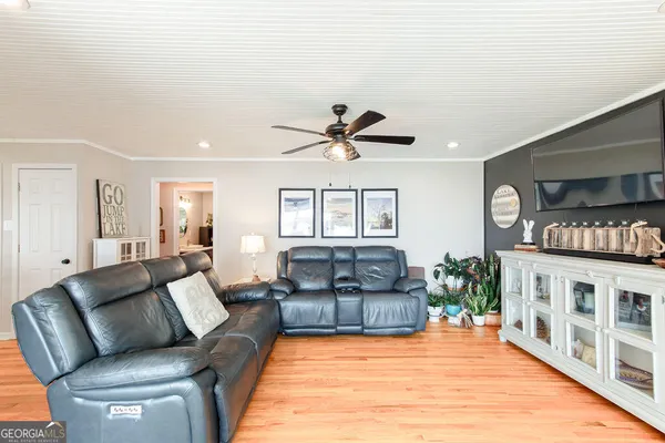 a living room with furniture wooden floor and a window