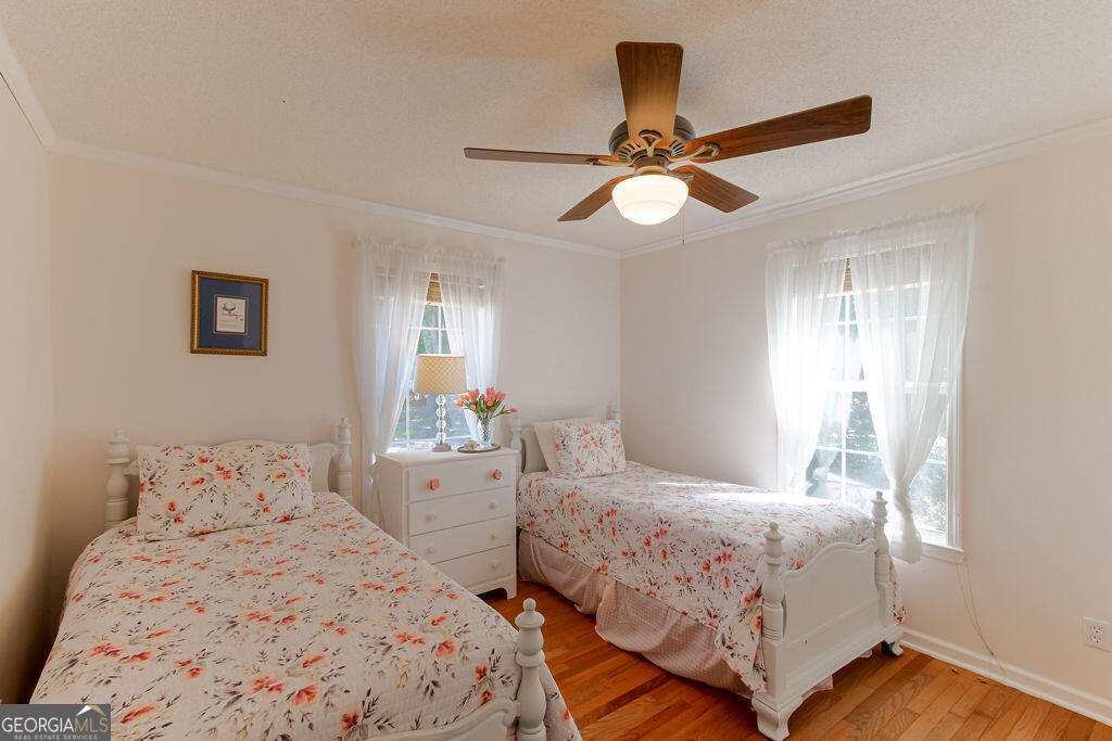 81 Docks Hook Lane Georgetown, GA 39854 - Photo 15 of 33 a bedroom with two large bed and a chandelier