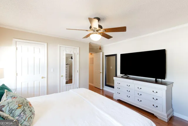 a bedroom with a flat screen tv and a bed