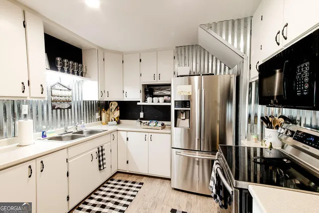 a kitchen with a refrigerator and a sink