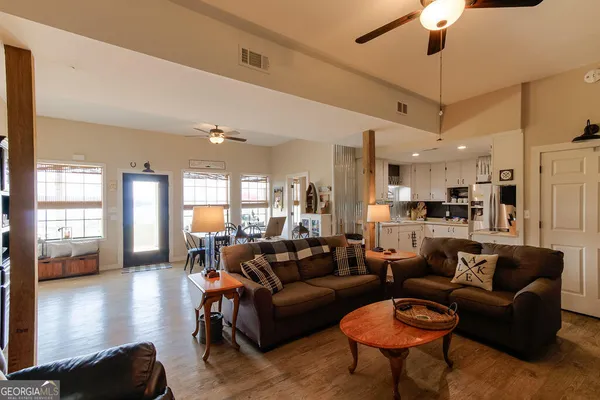 a living room with furniture wooden floor and chandelier