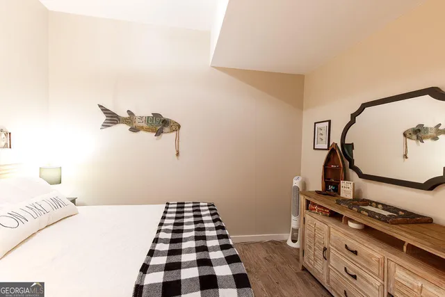 a bedroom with a bed and a black white checkered floor