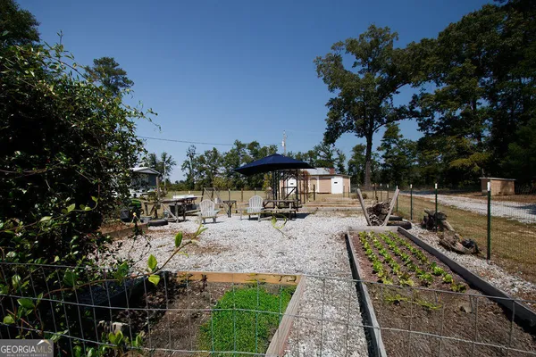 a view of a backyard with sitting area