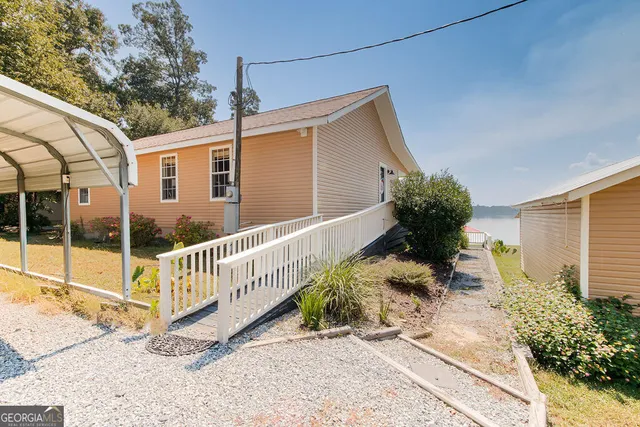 a view of a house with backyard and sitting area
