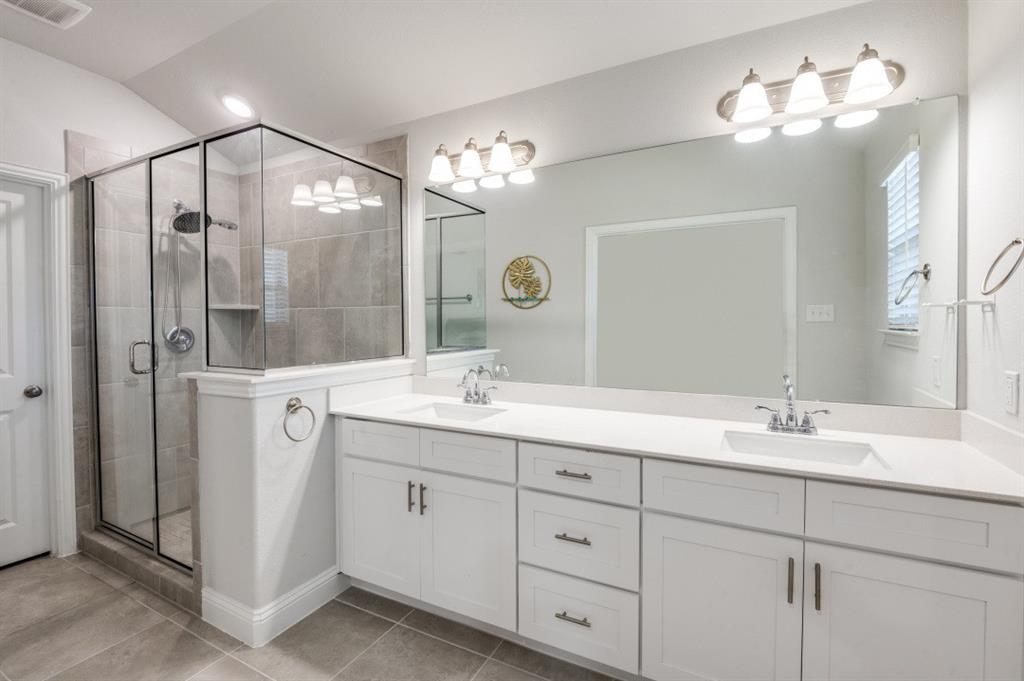 825 Heart Reef Road Plano, TX 75075 - Photo 11 of 12 Bathroom featuring double vanity, a stall shower, and light tile patterned floors