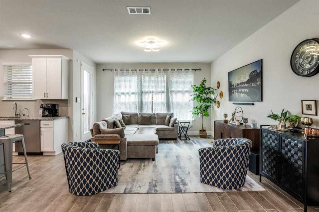 825 Heart Reef Road Plano, TX 75075 - Photo 2 of 12 Living room with light wood-type flooring and baseboards