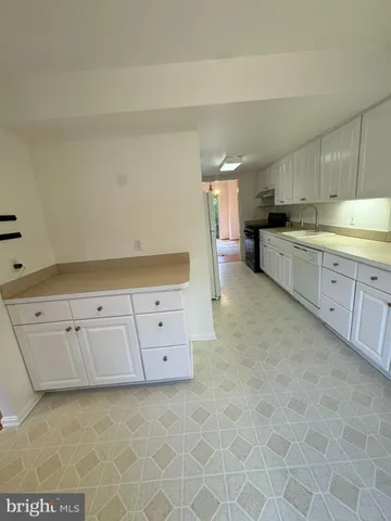 a view of a kitchen with cabinets