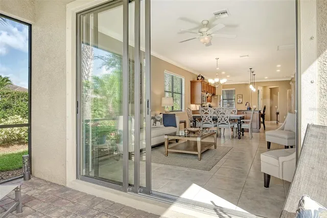 a living room with lots of furniture a large window and flat screen tv