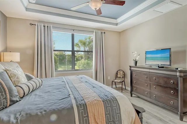 a bedroom with a large bed and a window