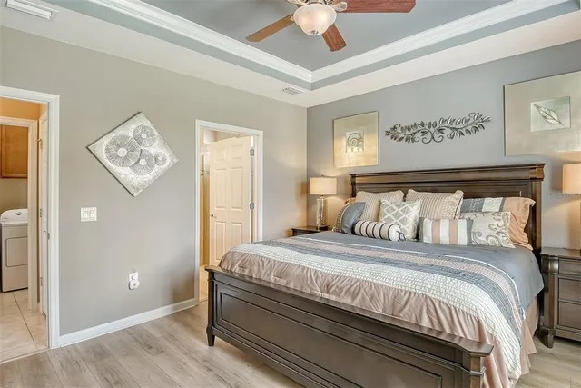 a bedroom with a bed and a painting on the wall