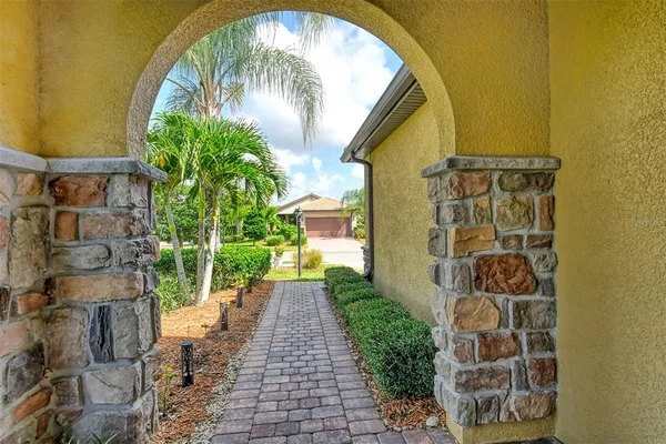 a view of a pathway of a house with a small yard