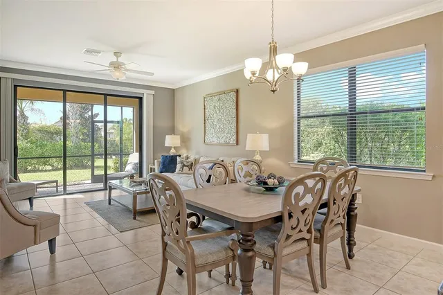 a view of a dining room with furniture large windows and wooden floor