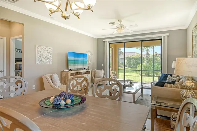 a living room with furniture and a floor to ceiling window
