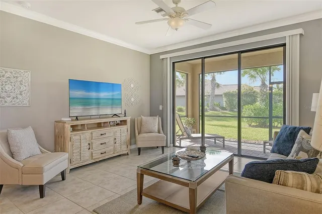 a living room with furniture a large window and a flat screen tv