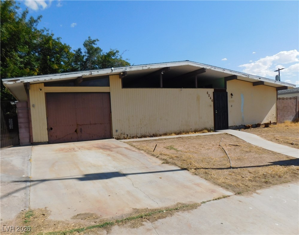 View of front of home with driveway and a garage