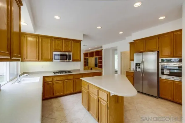 a large kitchen with stainless steel appliances lots of counter top space
