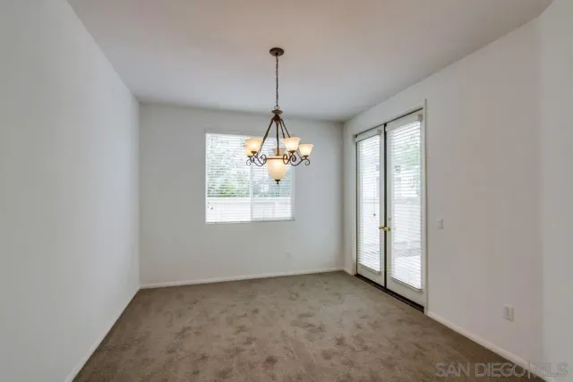 an empty room with windows and entrance