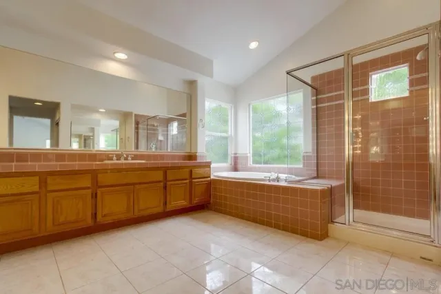 a large bathroom with a large tub shower and sink