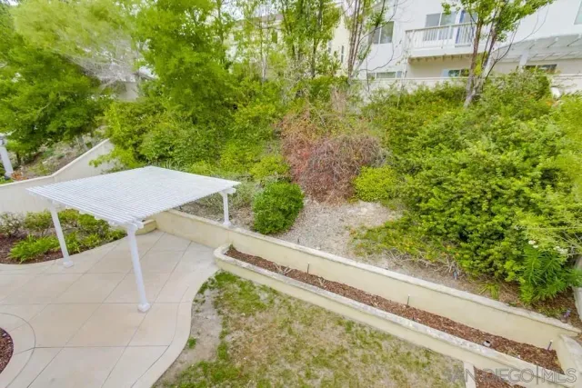 a view of a yard with potted plants