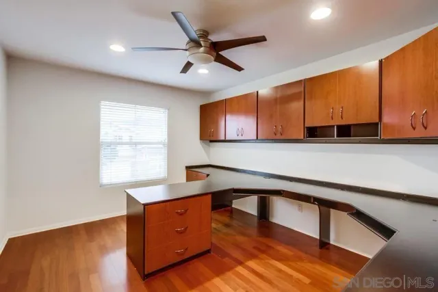 a kitchen with stainless steel appliances granite countertop a sink window and cabinets