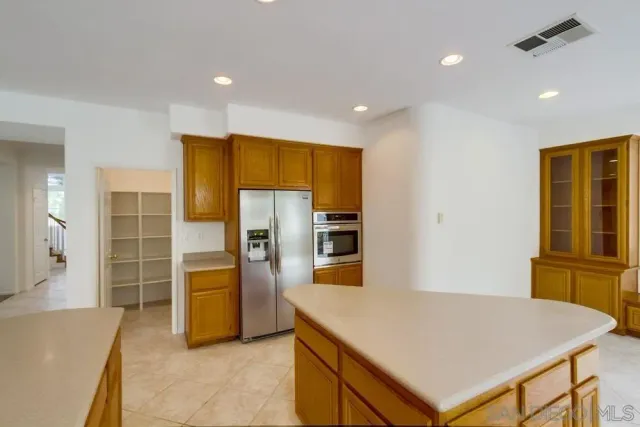 a kitchen with stainless steel appliances a refrigerator and a stove