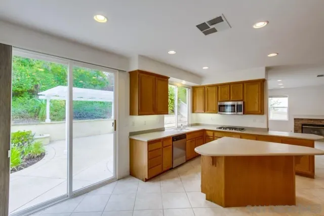 a kitchen with stainless steel appliances granite countertop a sink and a stove