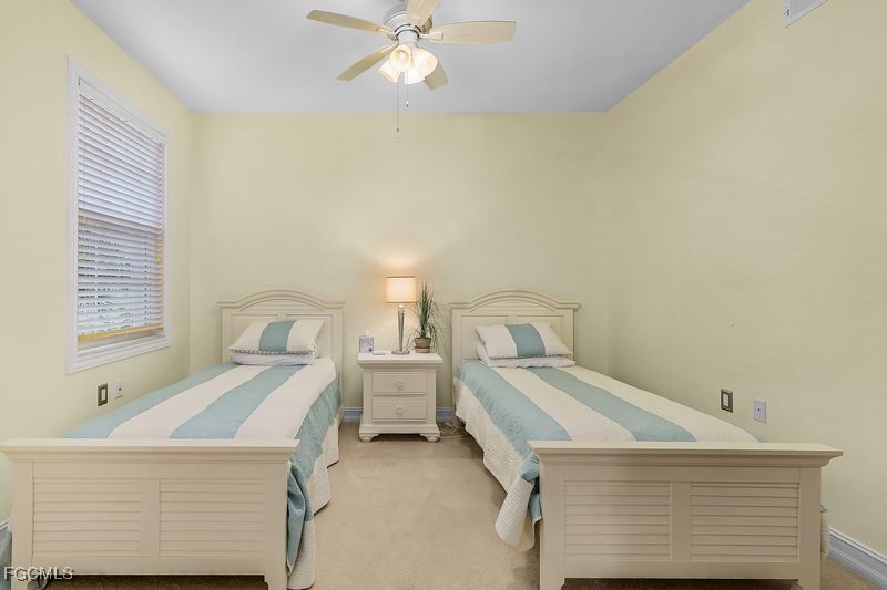 11079 Harbour Yacht Court, Unit 102 Fort Myers, FL 33908 - Photo 13 of 28 a room with a bed a lamp and a window