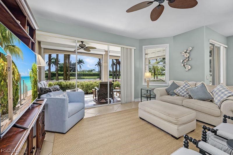 11079 Harbour Yacht Court, Unit 102 Fort Myers, FL 33908 - Photo 3 of 28 a living room with furniture and a large window