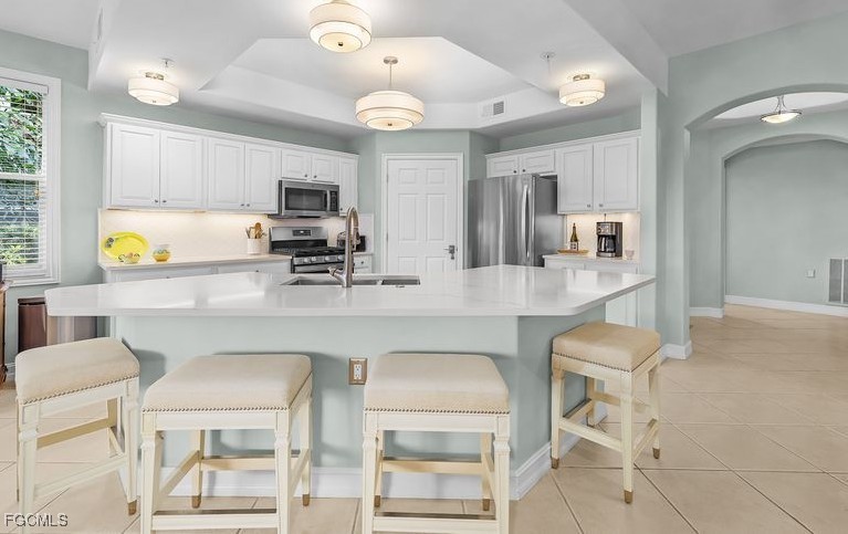 11079 Harbour Yacht Court, Unit 102 Fort Myers, FL 33908 - Photo 6 of 28 a kitchen with stainless steel appliances kitchen island granite countertop a sink and cabinets