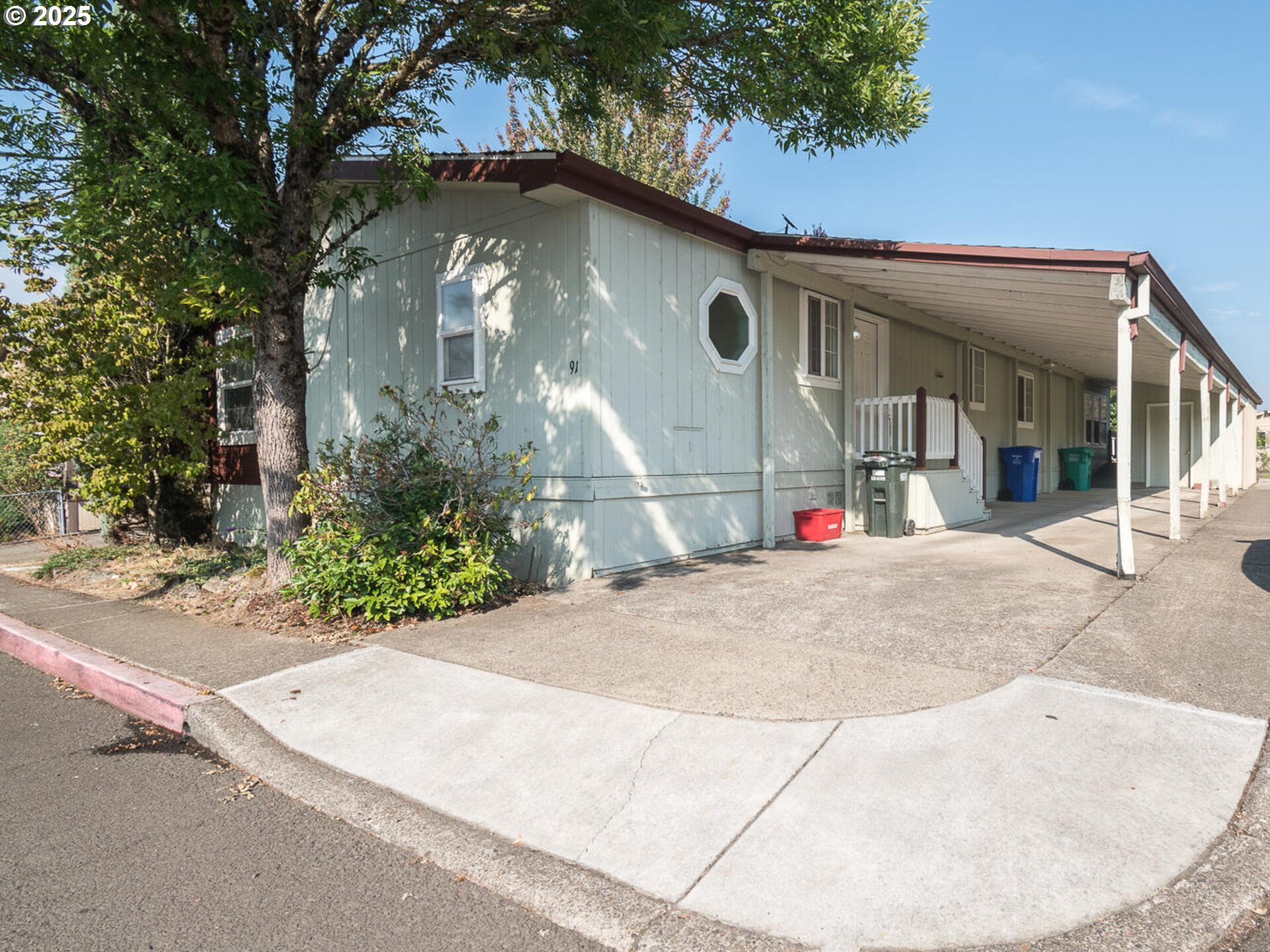 1949 Southeast Palmquist Road, Unit 91 Gresham, OR 97080 - Photo 1 of 40 a view of a house with a yard
