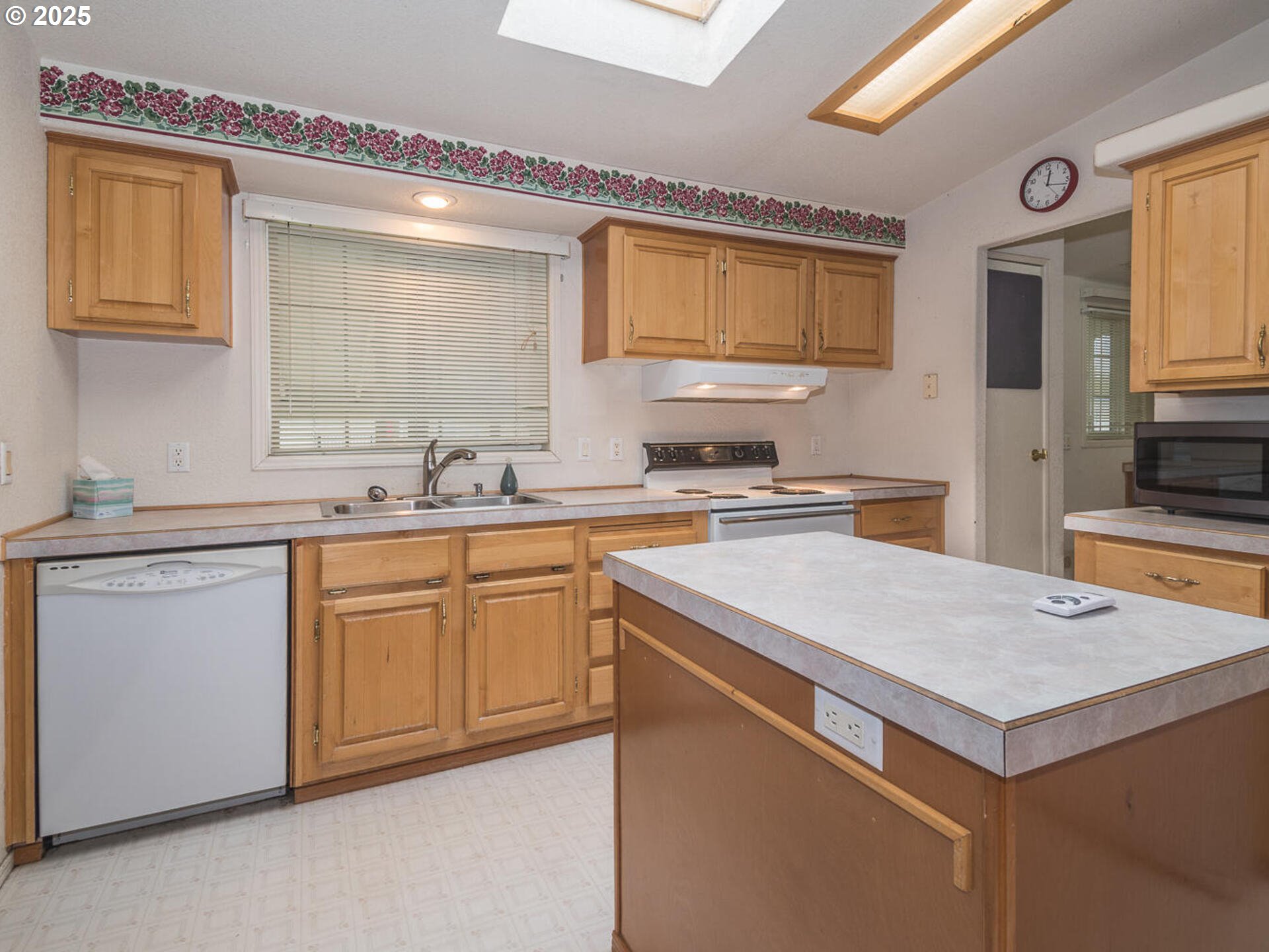 1949 Southeast Palmquist Road, Unit 91 Gresham, OR 97080 - Photo 13 of 40 a kitchen with granite countertop a sink and white cabinets