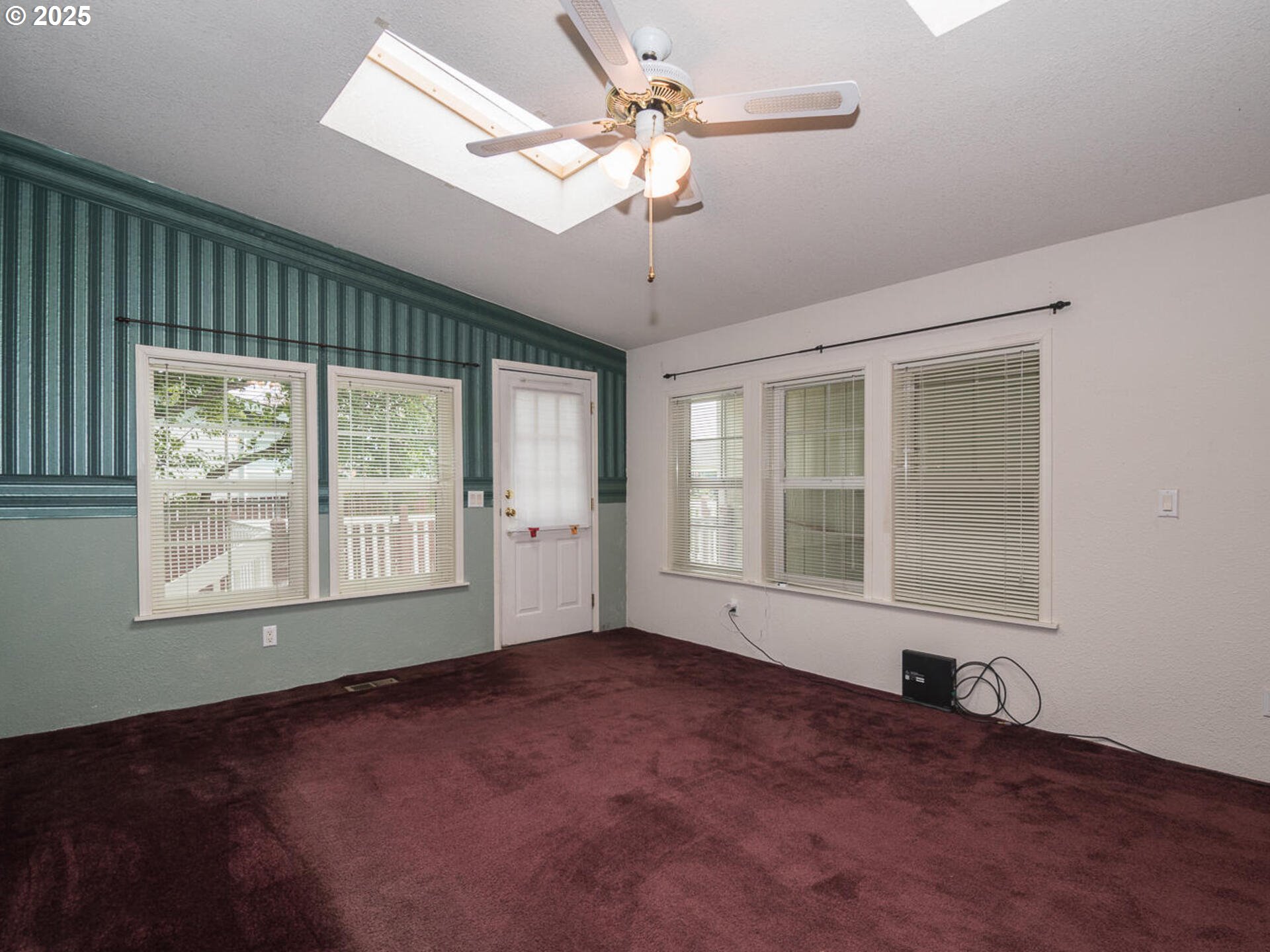 1949 Southeast Palmquist Road, Unit 91 Gresham, OR 97080 - Photo 15 of 40 an empty room with chandelier fan and windows