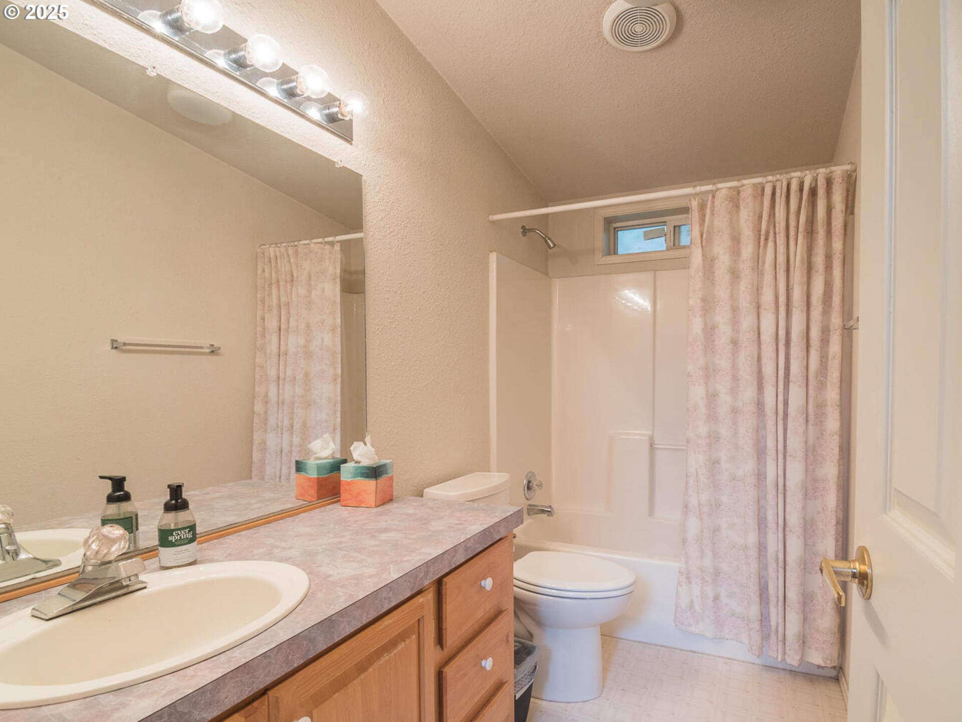 1949 Southeast Palmquist Road, Unit 91 Gresham, OR 97080 - Photo 18 of 40 a bathroom with a granite countertop sink a toilet and a mirror