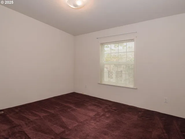 a view of empty room with floor to ceiling window