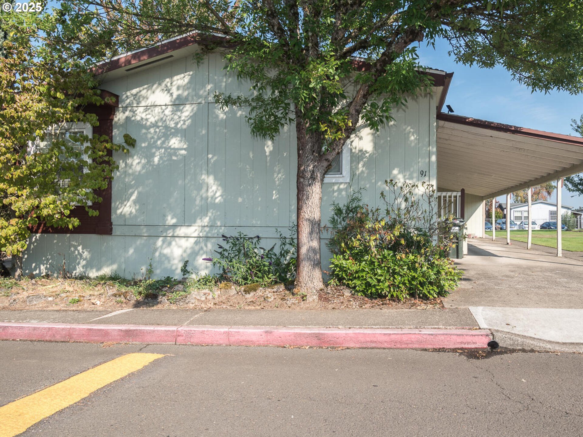 1949 Southeast Palmquist Road, Unit 91 Gresham, OR 97080 - Photo 2 of 40 a backyard of a house with lots of green space