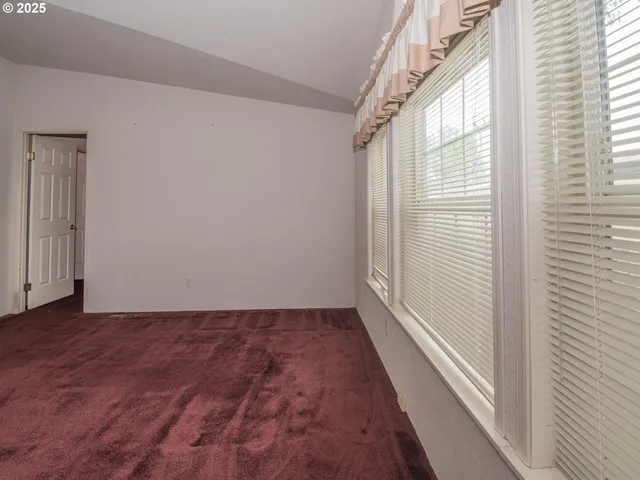 a view of room with window and ceiling fan