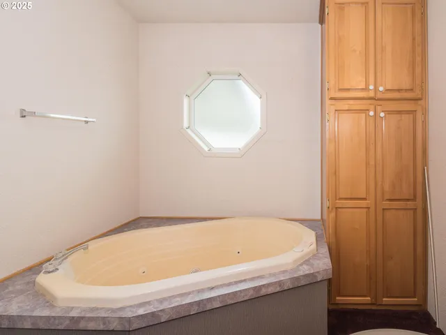a bathroom with a granite countertop toilet a sink and a mirror