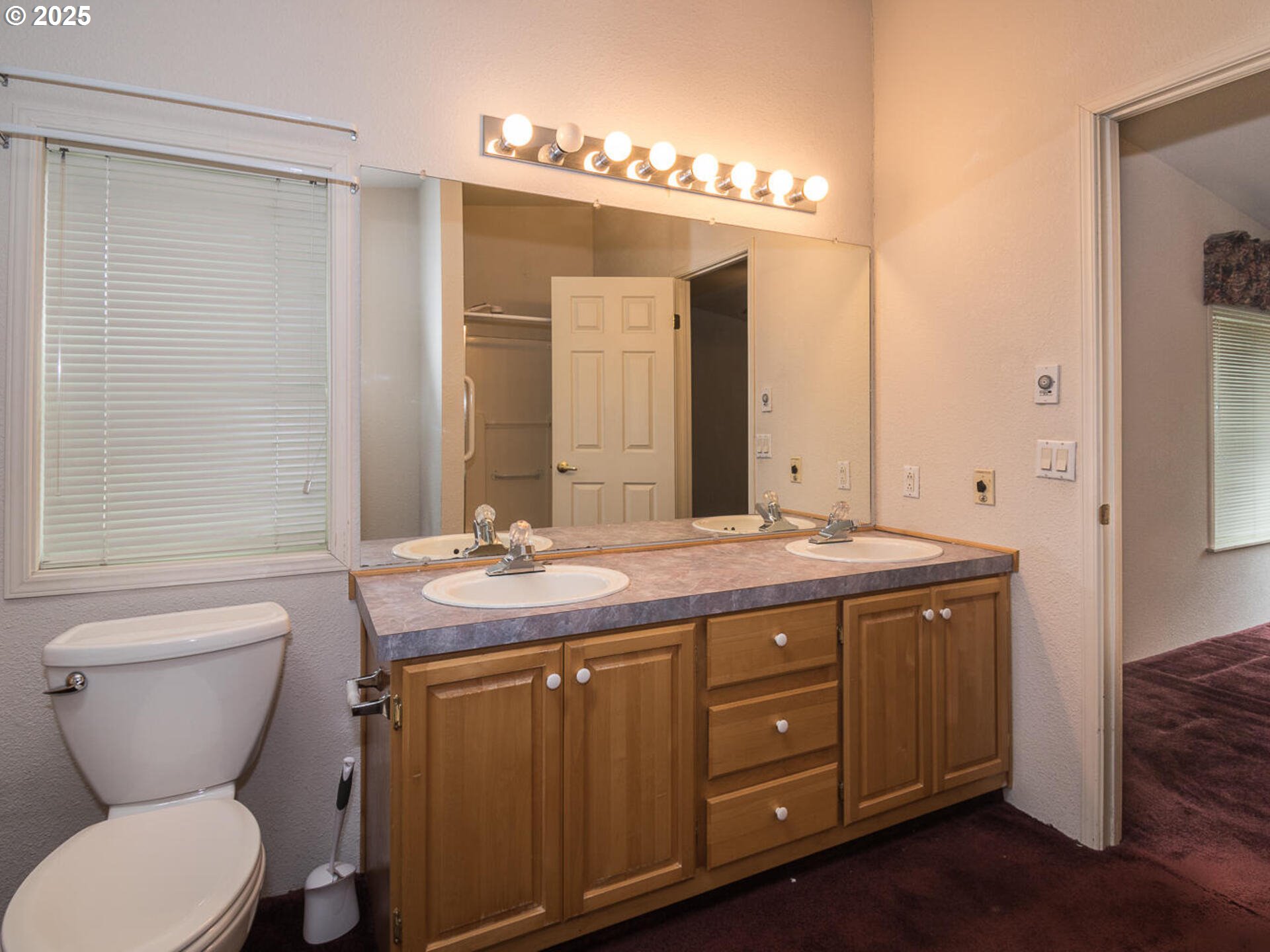 1949 Southeast Palmquist Road, Unit 91 Gresham, OR 97080 - Photo 34 of 40 a bathroom with a granite countertop toilet a sink and a mirror