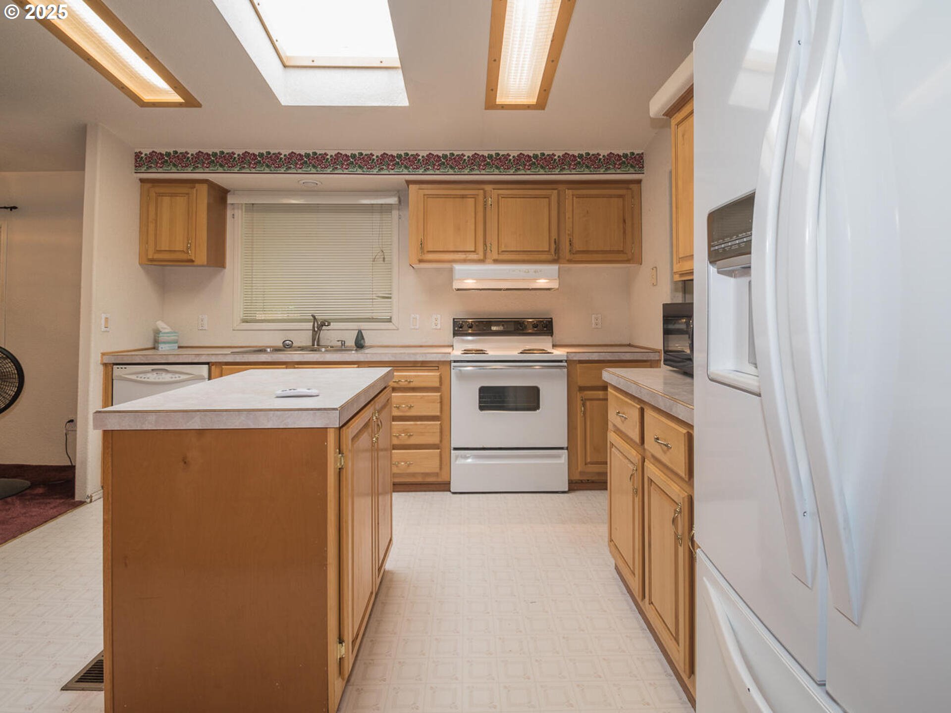 1949 Southeast Palmquist Road, Unit 91 Gresham, OR 97080 - Photo 10 of 40 a kitchen with stainless steel appliances a stove a sink and a refrigerator