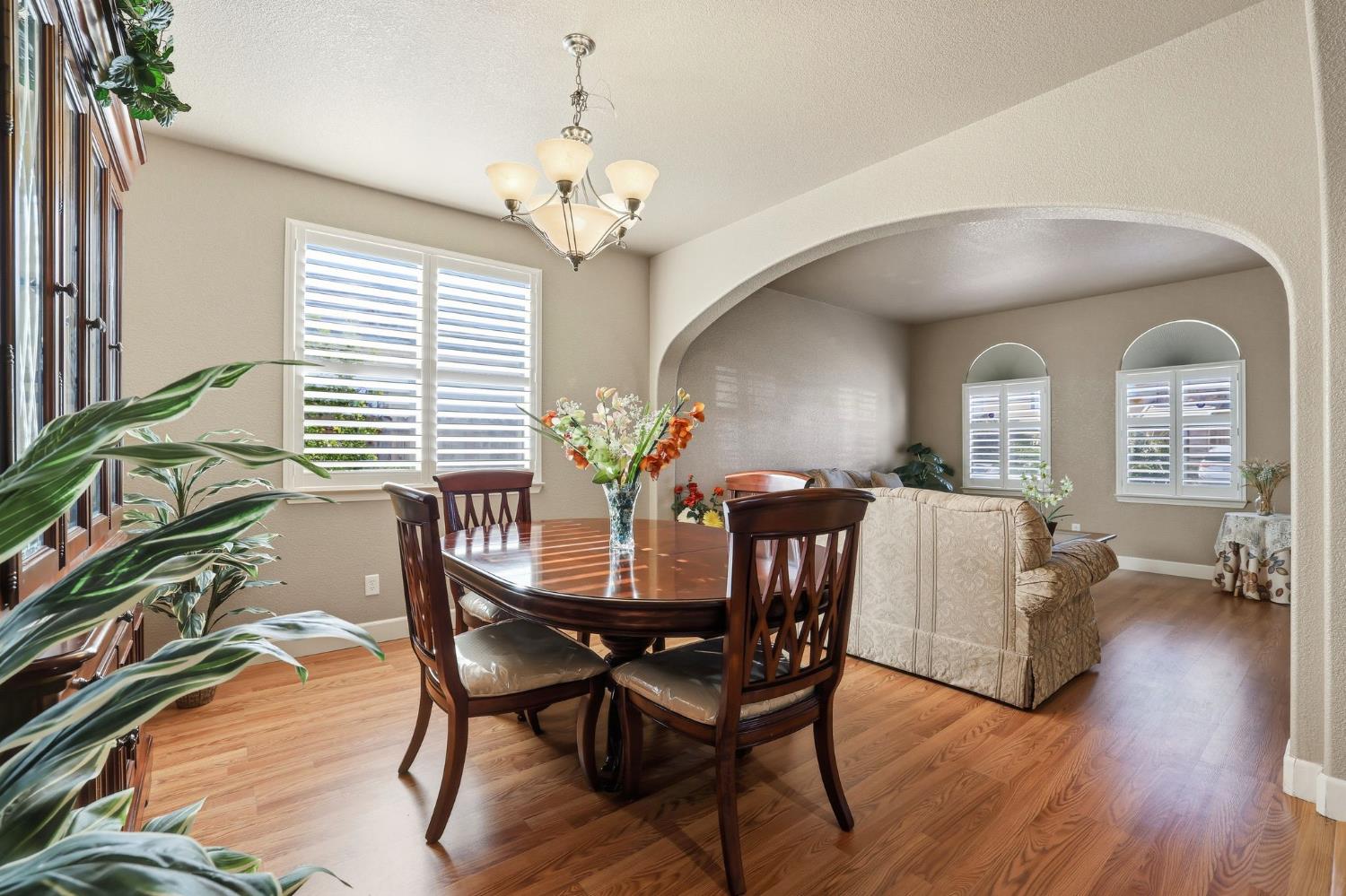 1730 Tasca Lane Manteca, CA 95337 - Photo 12 of 83 a view of a dining room with furniture and wooden floor