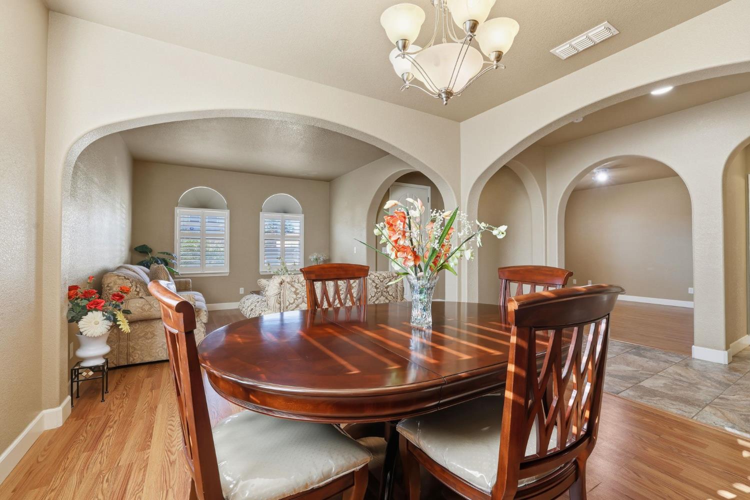 1730 Tasca Lane Manteca, CA 95337 - Photo 13 of 83 a view of a dining room with furniture and wooden floor