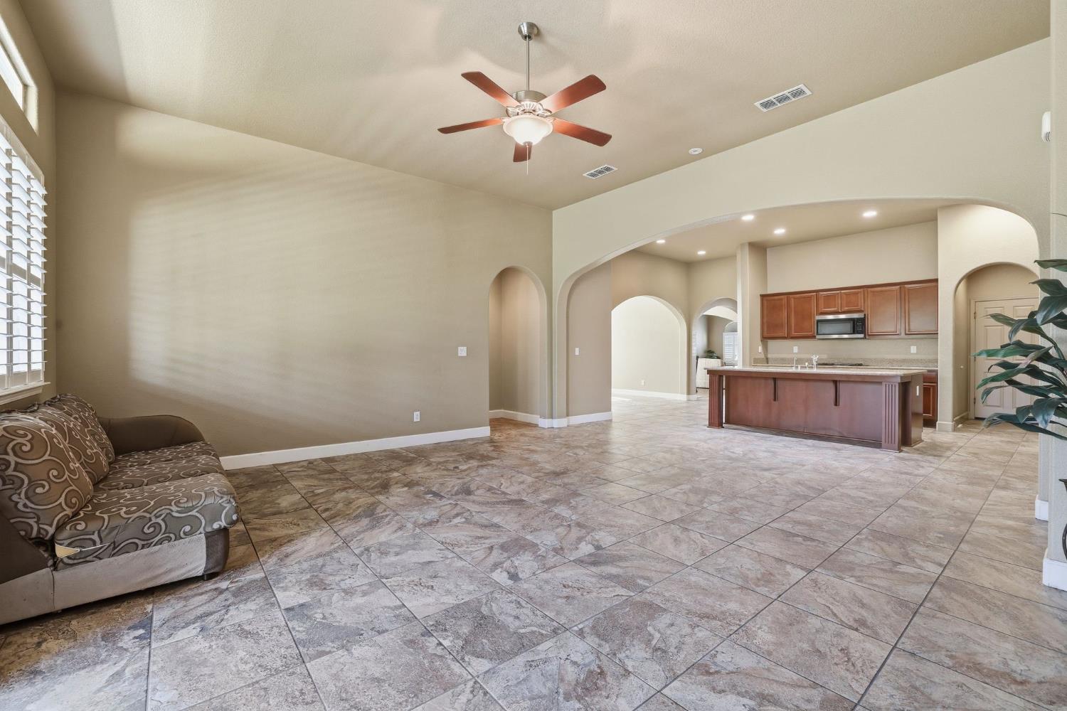 1730 Tasca Lane Manteca, CA 95337 - Photo 29 of 83 a living room with furniture and a chandelier