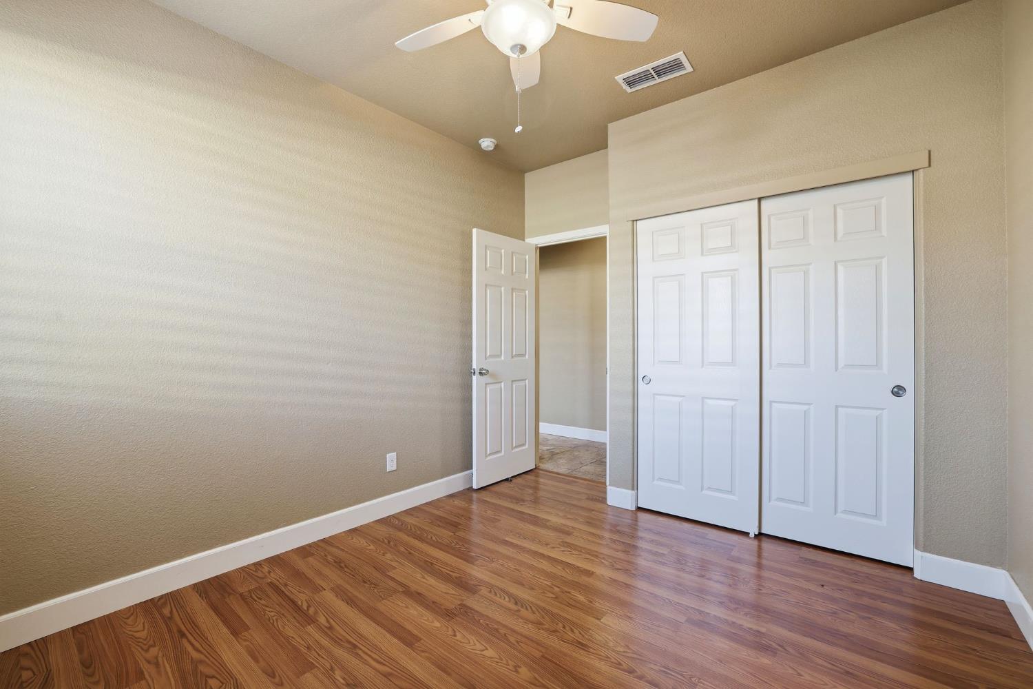 1730 Tasca Lane Manteca, CA 95337 - Photo 33 of 83 a view of an empty room with wooden floor