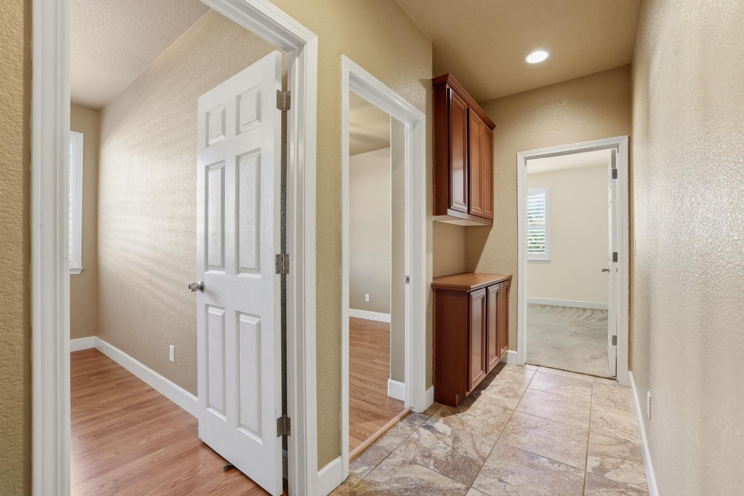 1730 Tasca Lane Manteca, CA 95337 - Photo 34 of 83 a view of a hallway with closet and wooden floor
