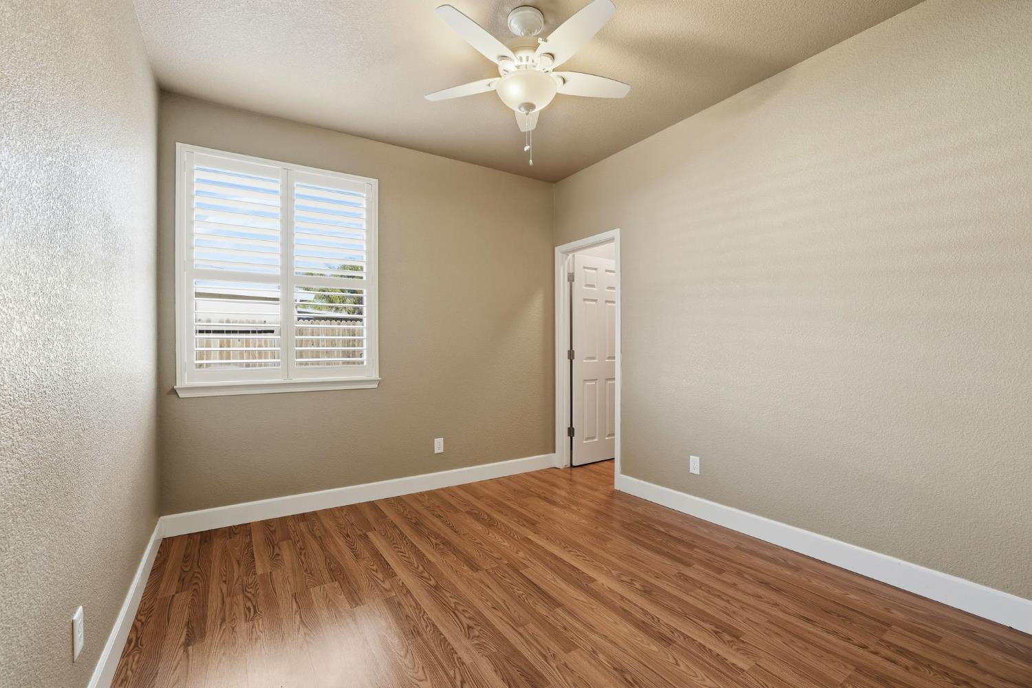 1730 Tasca Lane Manteca, CA 95337 - Photo 35 of 83 an empty room with wooden floor and windows