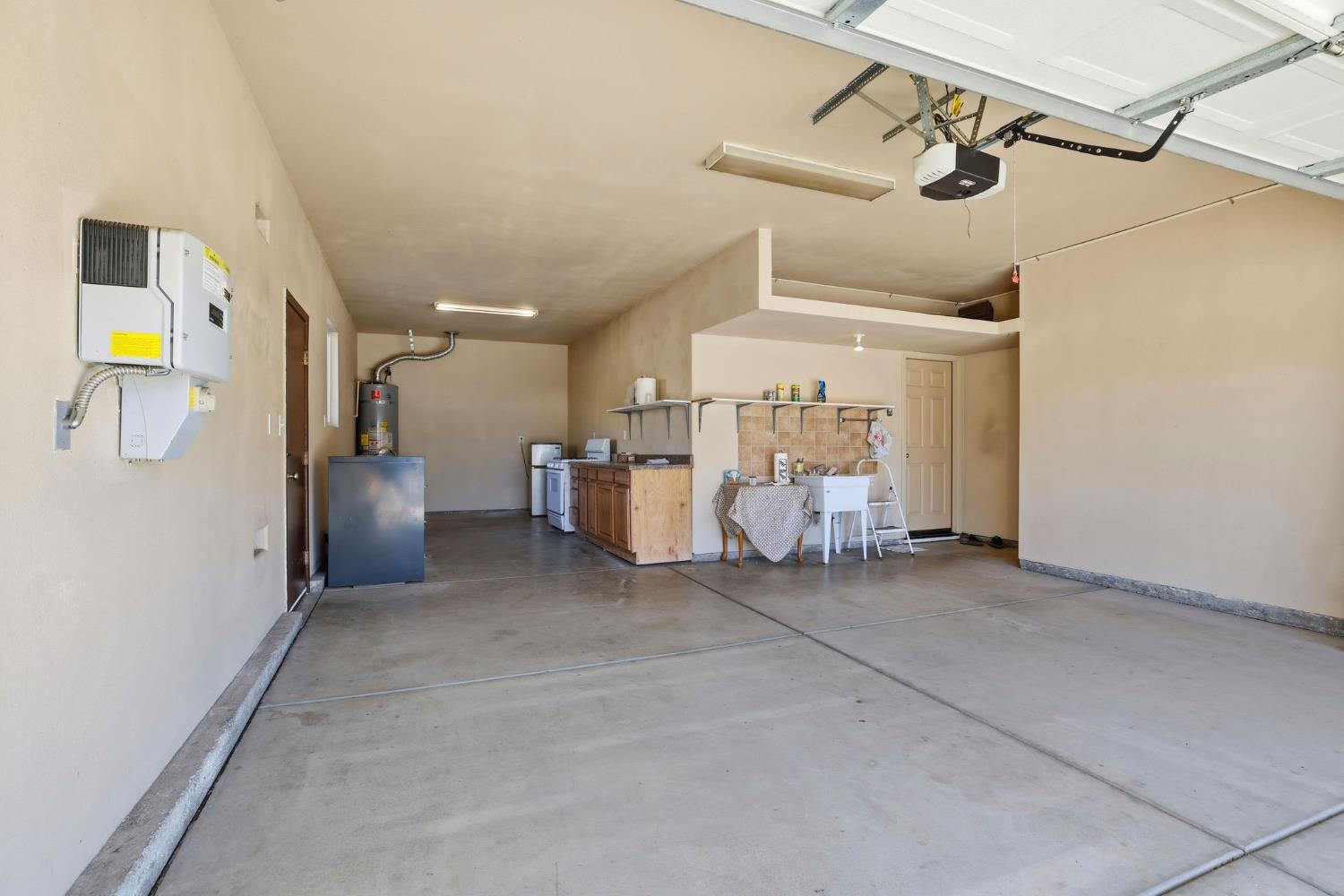 1730 Tasca Lane Manteca, CA 95337 - Photo 58 of 83 garage featuring water heater and a garage door opener