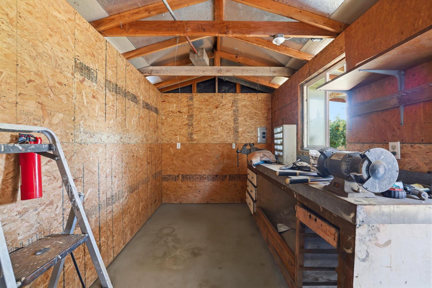 1730 Tasca Lane Manteca, CA 95337 - Photo 76 of 83 miscellaneous room with vaulted ceiling and concrete flooring -shed