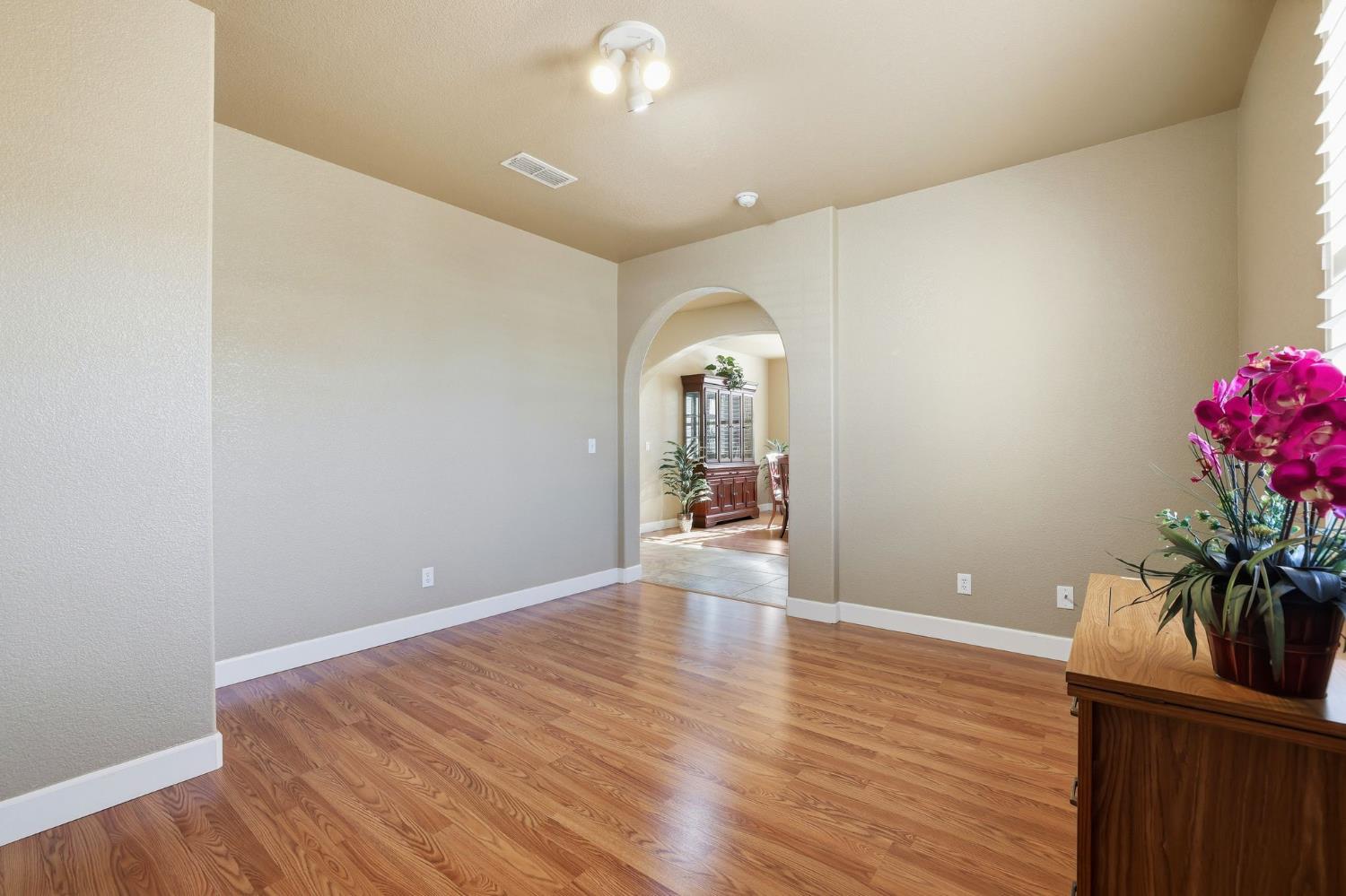 1730 Tasca Lane Manteca, CA 95337 - Photo 10 of 83 a view of a room with wooden floor and potted plant
