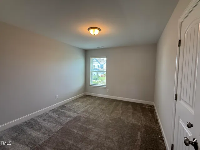 a bathroom with a granite countertop double vanity sink and a mirror